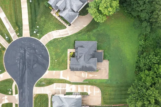 an aerial view of a house with garden space and street view