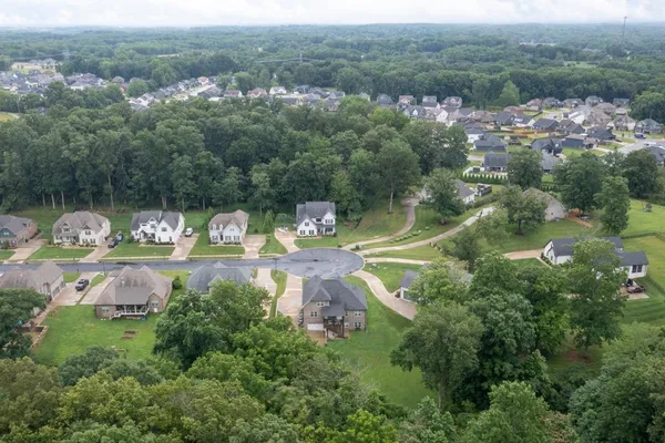 an aerial view of a house with a yard basket ball court and outdoor seating