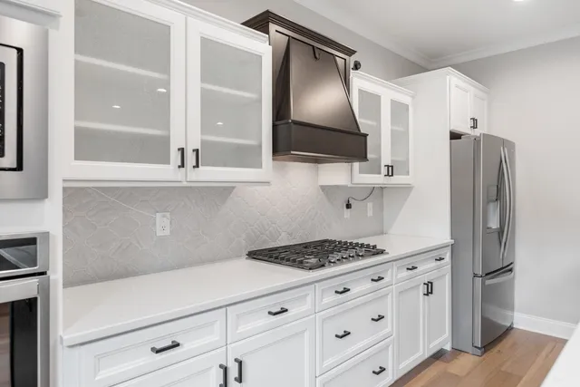 a kitchen with stainless steel appliances a refrigerator stove and sink