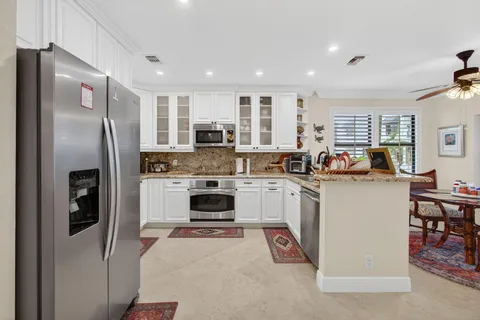 a kitchen with a refrigerator a stove and a sink