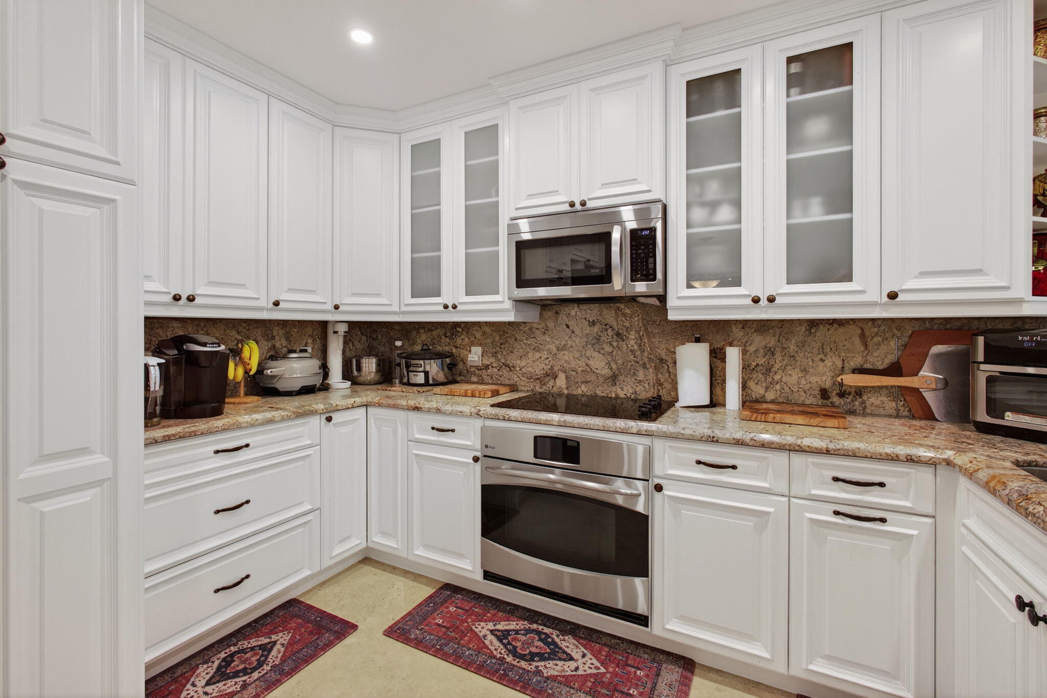 170 Celestial Way, Unit 35 Juno Beach, FL 33408 - Photo 20 of 53 a kitchen with stainless steel appliances granite countertop a stove a microwave and cabinets