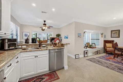 a very nice looking living room with stainless steel appliances granite countertop furniture and a kitchen view