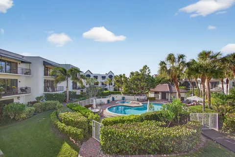 a view of a hallway to a livingroom with furniture and wooden floor