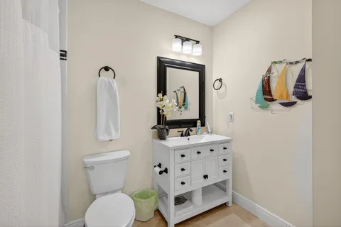 a bathroom with a sink a toilet and a mirror