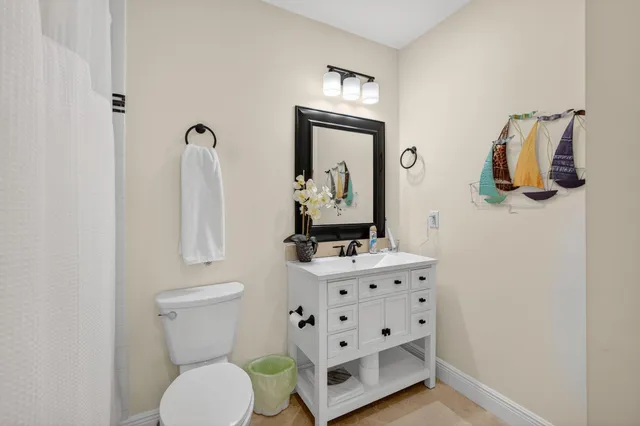 a bathroom with a sink a toilet and a mirror