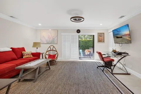 a living room with furniture a rug and a flat screen tv