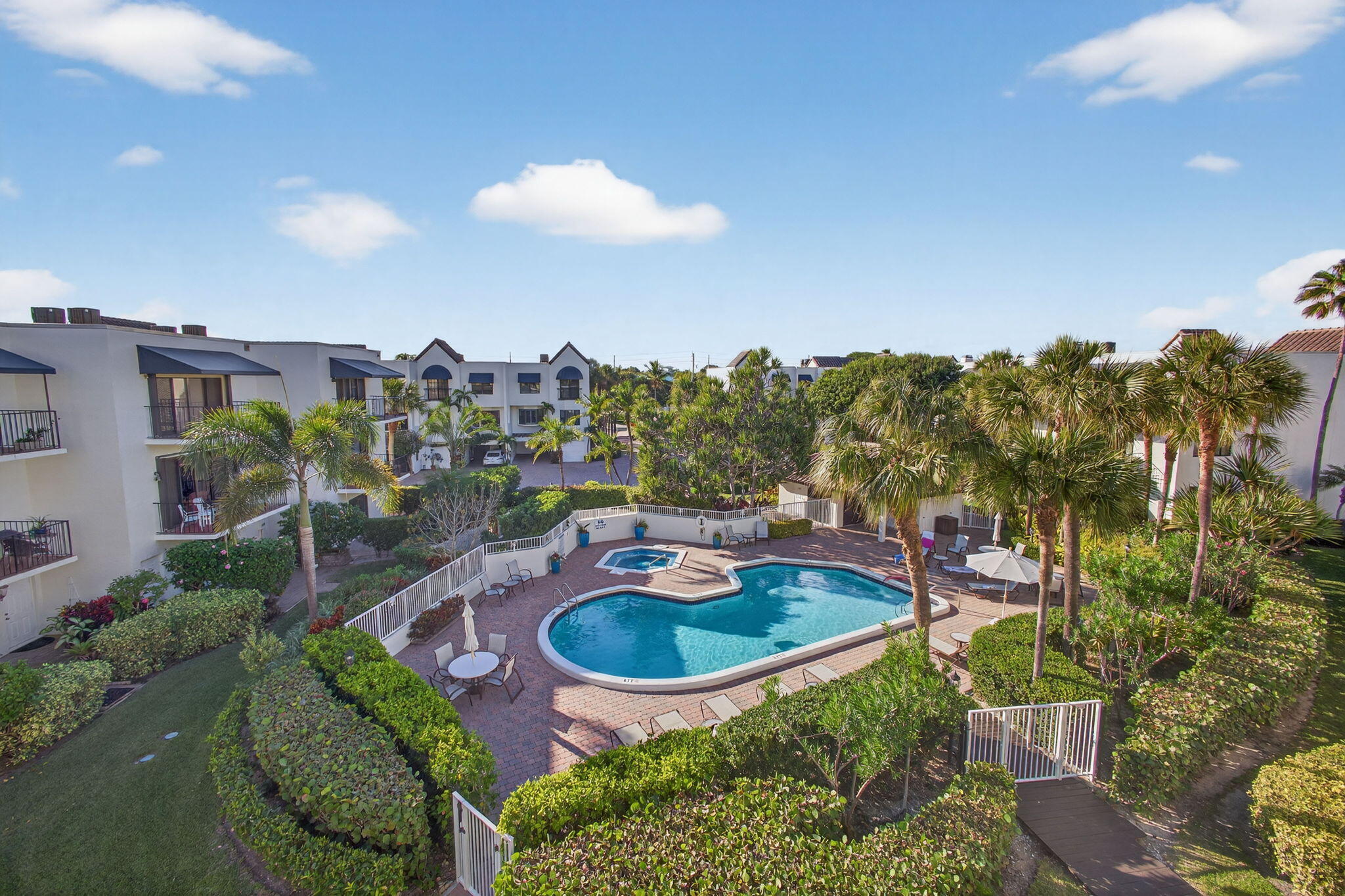 170 Celestial Way, Unit 35 Juno Beach, FL 33408 - Photo 43 of 53 a swimming pool with outdoor seating and yard