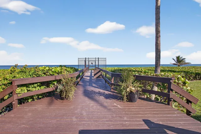 a view of pool with a yard and plants