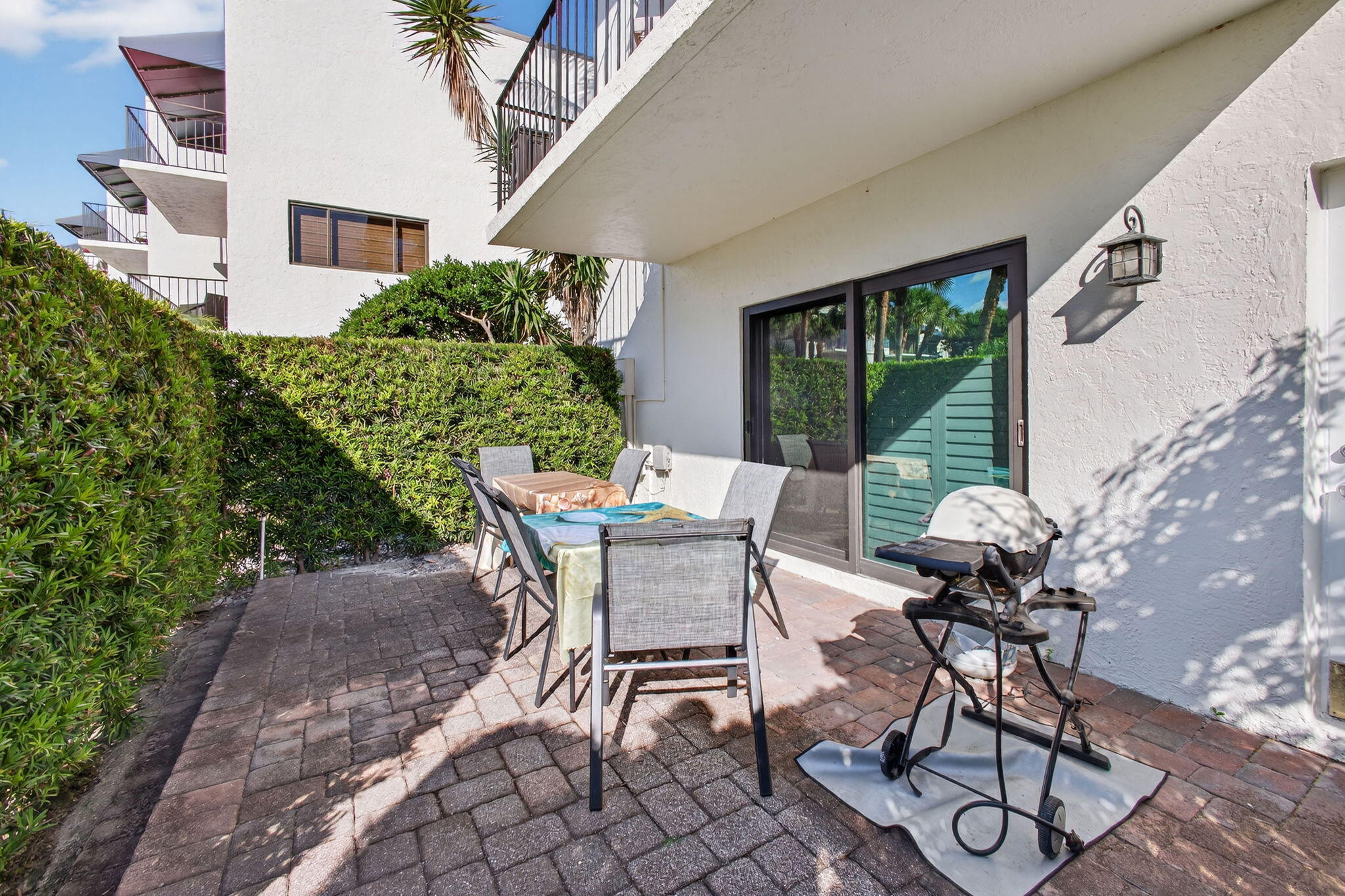 170 Celestial Way, Unit 35 Juno Beach, FL 33408 - Photo 8 of 53 a view of a patio with table and chairs and potted plants