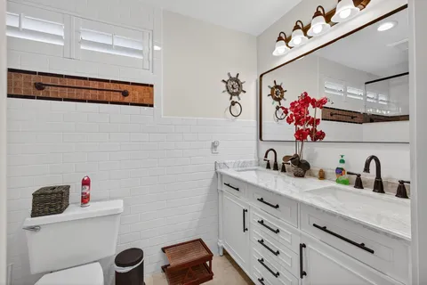 a bathroom with a sink mirror and vanity