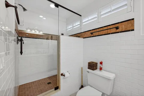 a bathroom with a toilet sink and shower