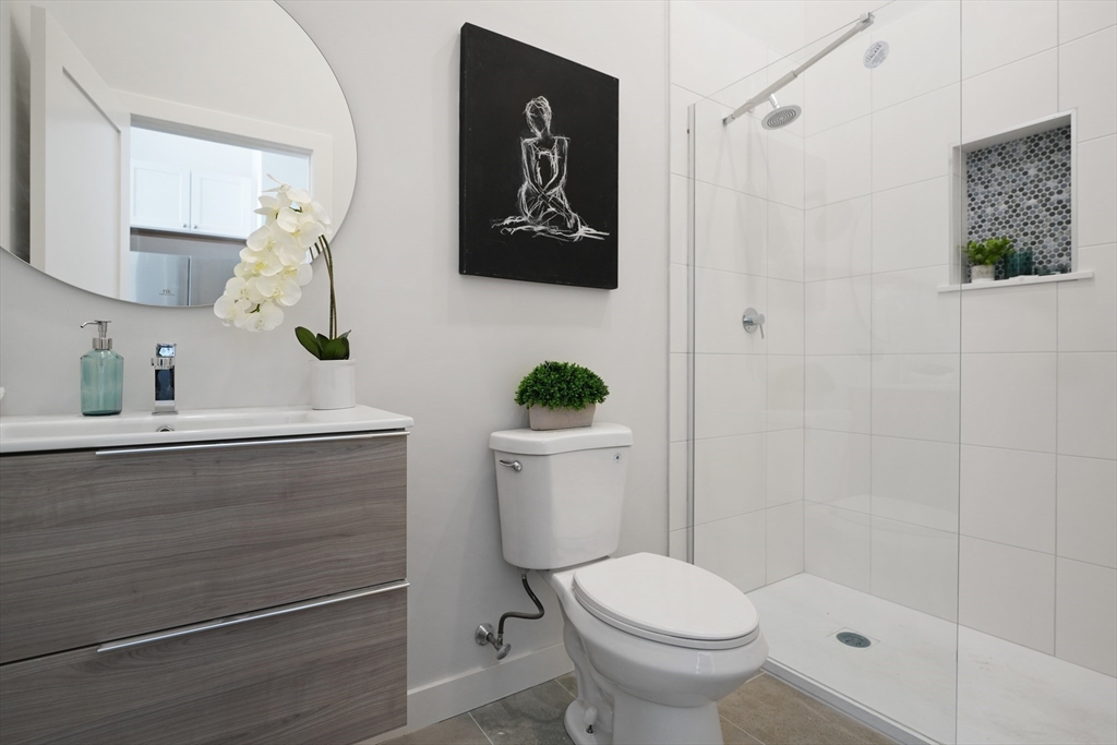 403 Division Street, Unit 13 Fall River, MA 02721 - Photo 15 of 29 a bathroom with a toilet a sink and mirror