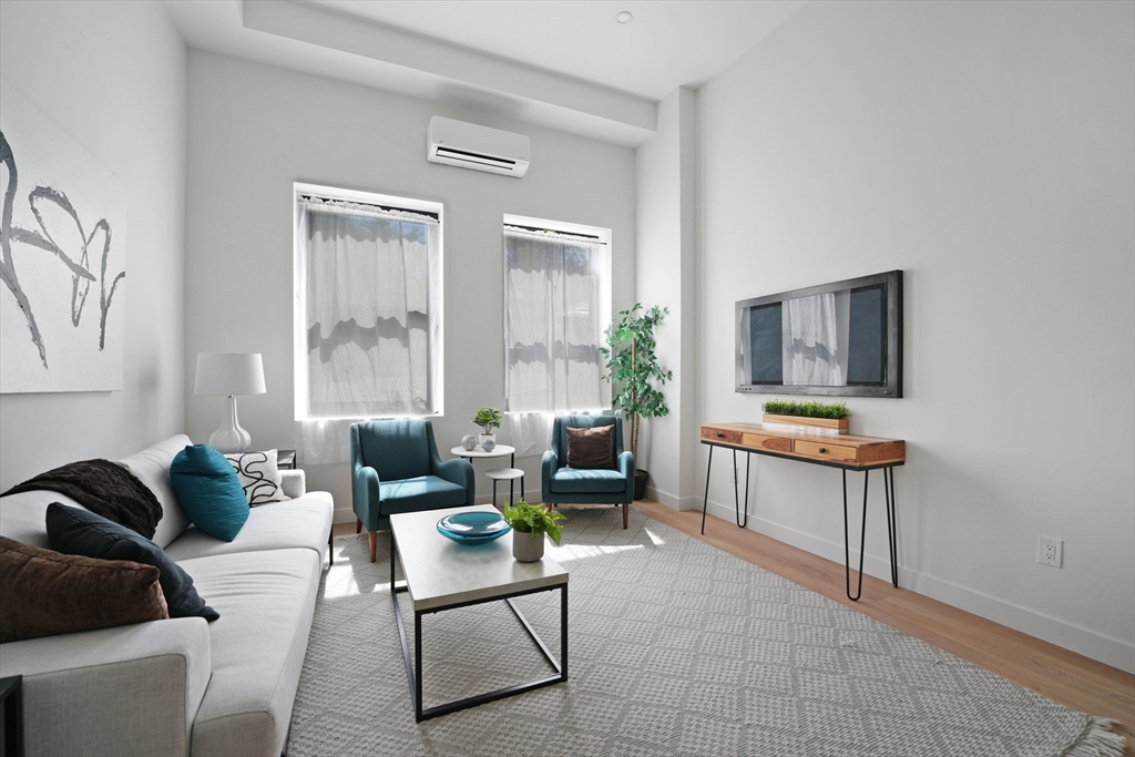 403 Division Street, Unit 13 Fall River, MA 02721 - Photo 7 of 29 a living room with furniture and a flat screen tv