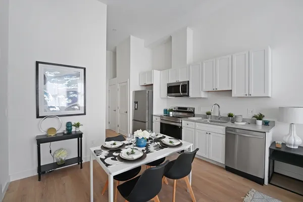 a kitchen with stainless steel appliances kitchen island granite countertop a stove a sink and a refrigerator