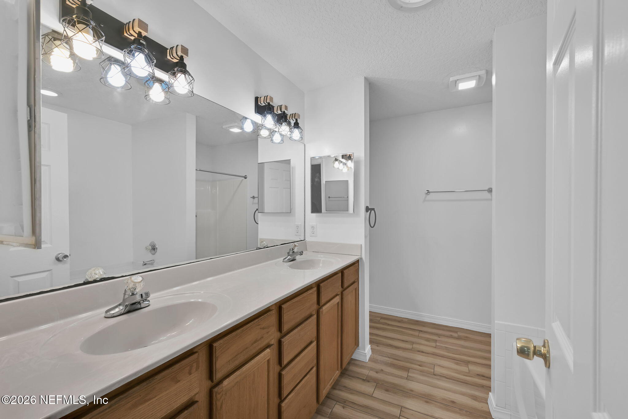 1110 Woodlawn Road, Unit D St. Augustine, FL 32084 - Photo 29 of 40 a bathroom with a double vanity sink and a mirror