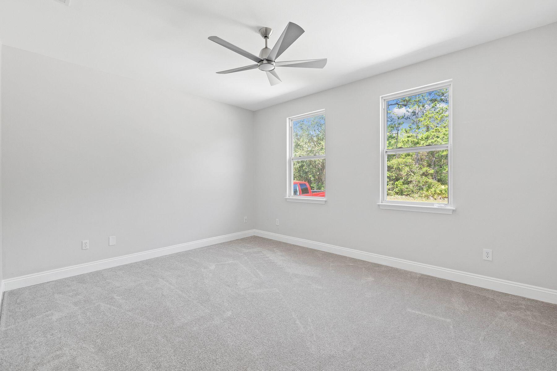 229 County Line Road Niceville, FL 32578 - Photo 13 of 43 an empty room with windows and ceiling fan