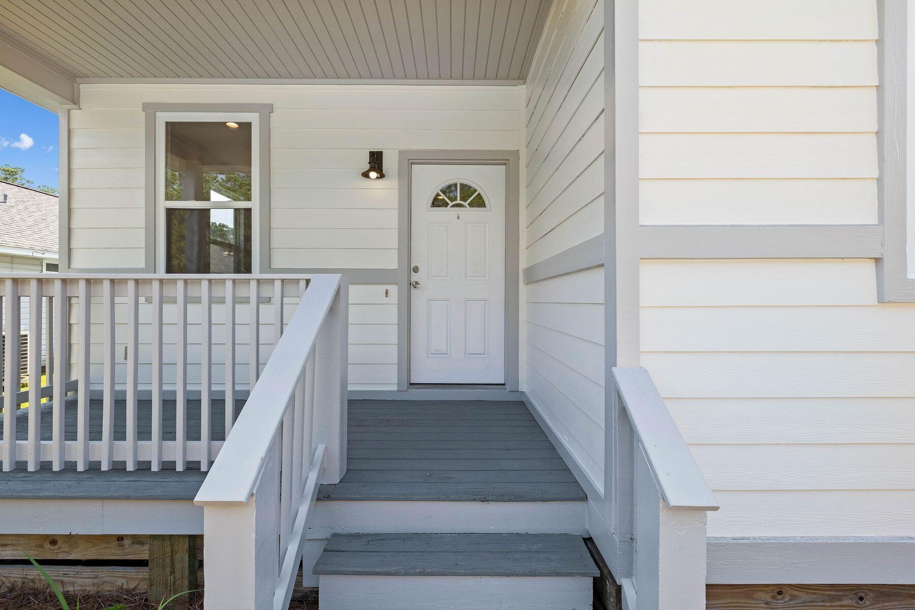229 County Line Road Niceville, FL 32578 - Photo 3 of 43 a view of staircase with lots of frames on wall and a window