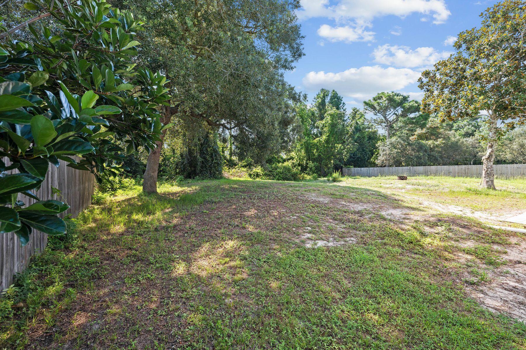 229 County Line Road Niceville, FL 32578 - Photo 33 of 43 a view of outdoor space with a garden and trees