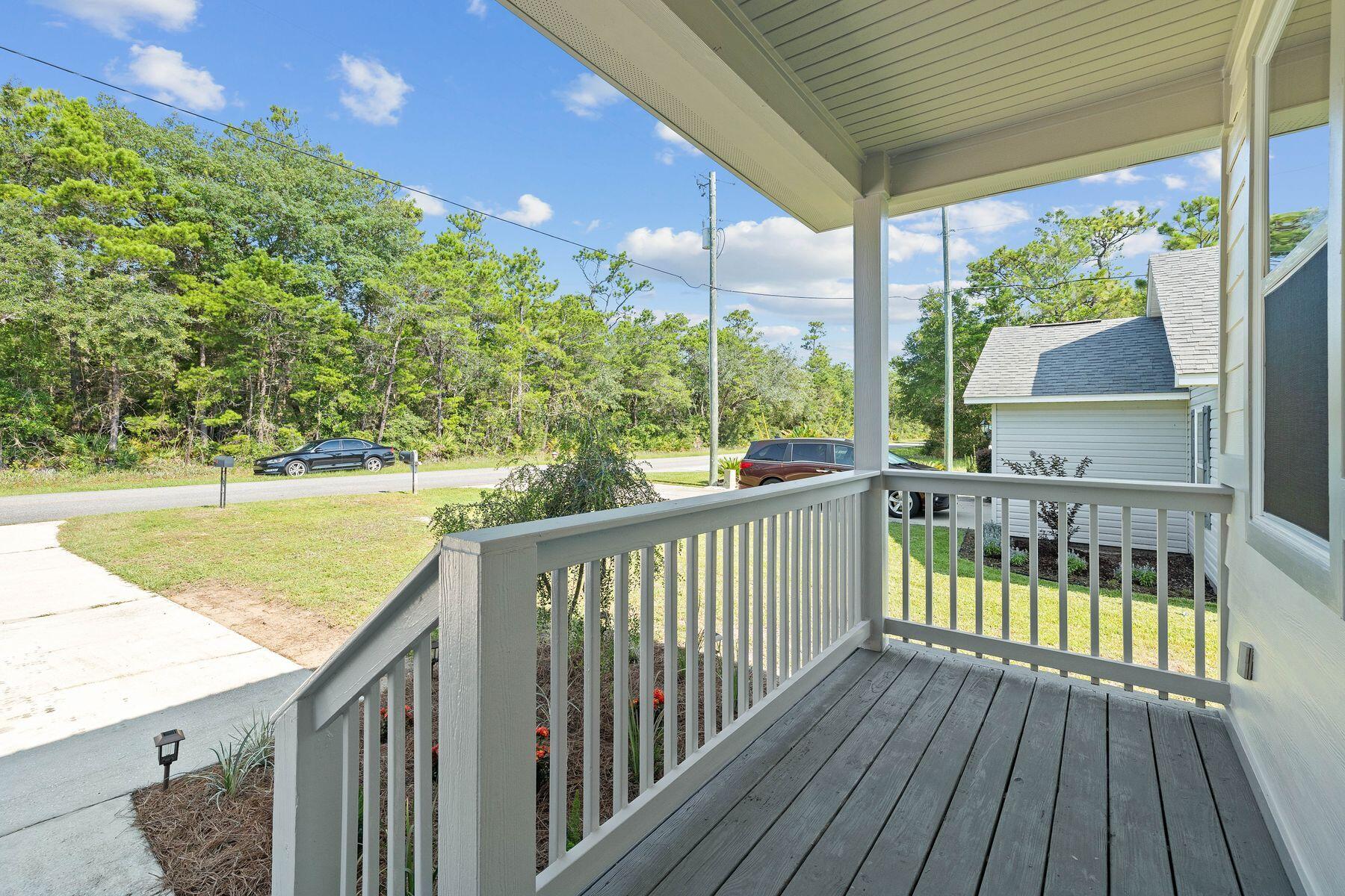 229 County Line Road Niceville, FL 32578 - Photo 4 of 43 a view of balcony with wooden floor and outdoor seating