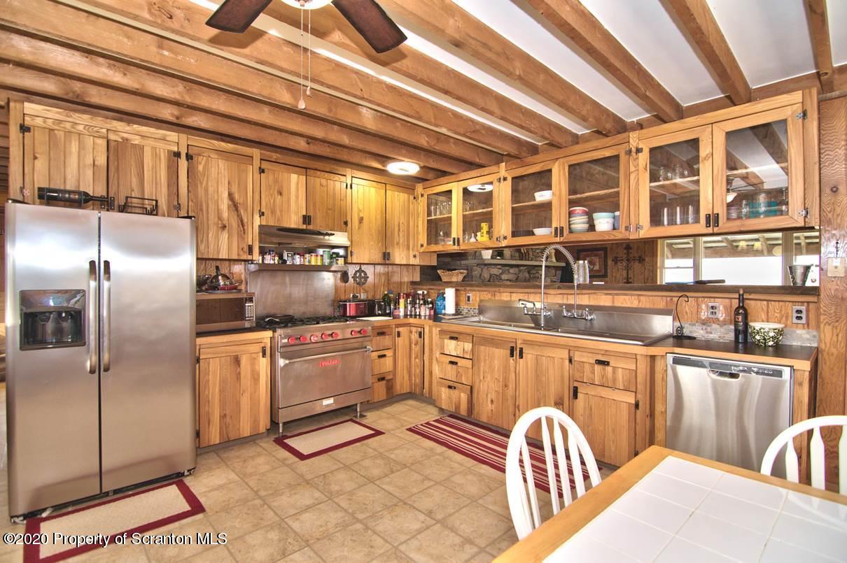 293 State Rte 1002 Tunkhannock, PA 18657 - Photo 12 of 71 a kitchen with stainless steel appliances granite countertop a stove a sink dishwasher and cabinets