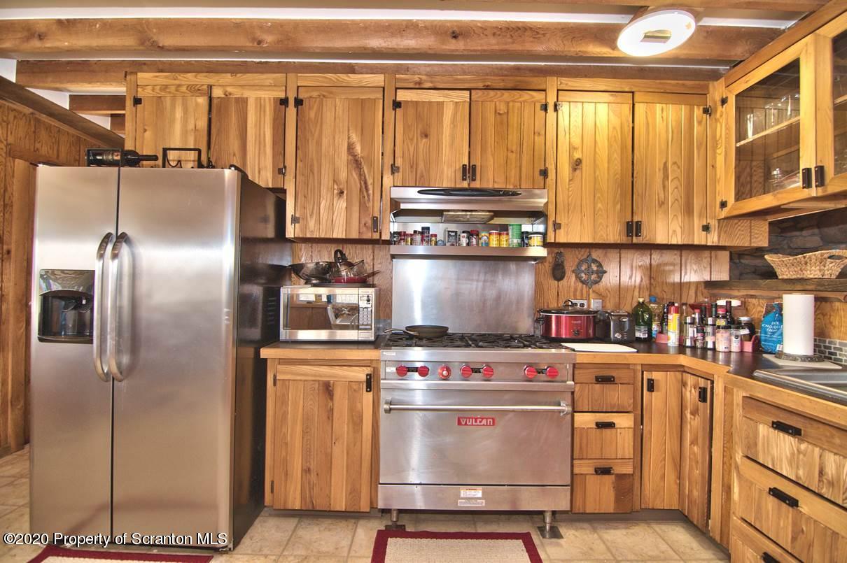 293 State Rte 1002 Tunkhannock, PA 18657 - Photo 13 of 71 a kitchen with a stove and a refrigerator