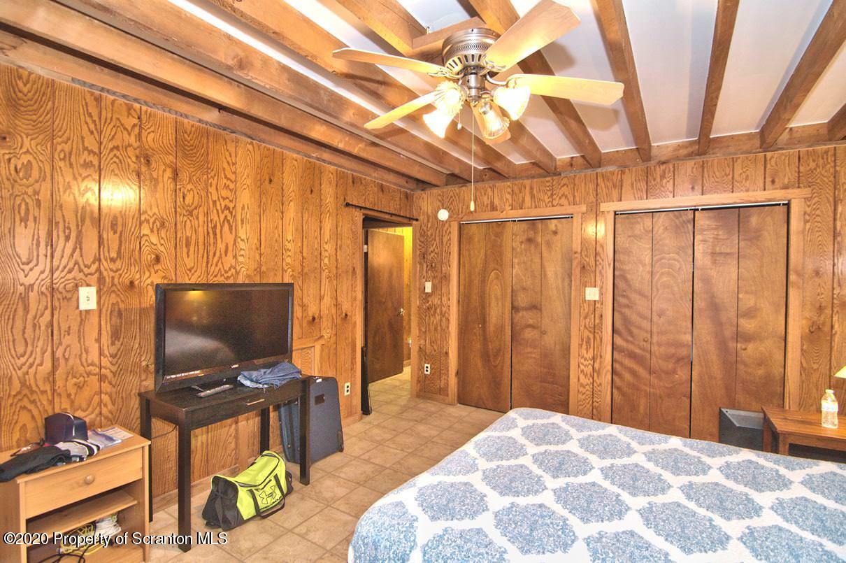 293 State Rte 1002 Tunkhannock, PA 18657 - Photo 18 of 71 a bedroom with a bed and a flat screen tv