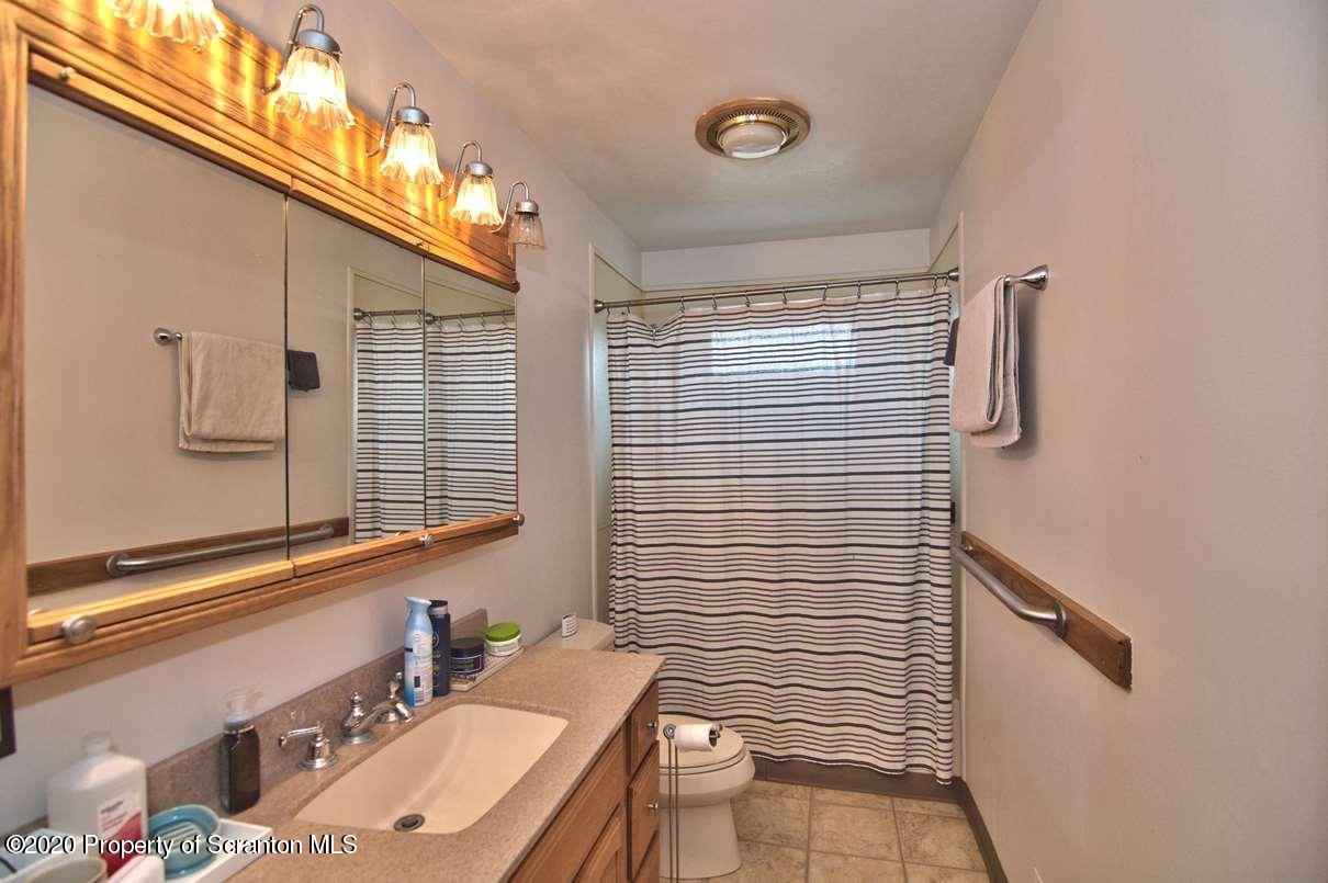 293 State Rte 1002 Tunkhannock, PA 18657 - Photo 19 of 71 a bathroom with a sink a toilet and shower curtain
