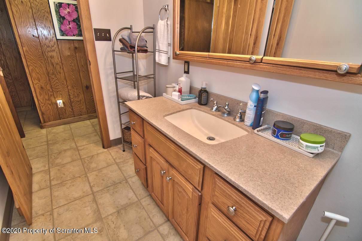 293 State Rte 1002 Tunkhannock, PA 18657 - Photo 21 of 71 a bathroom with a sink and a mirror