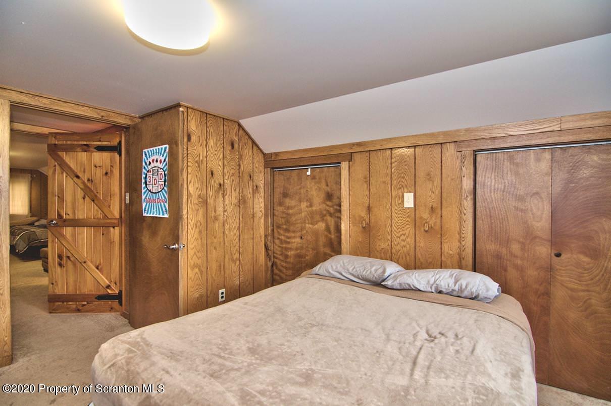 293 State Rte 1002 Tunkhannock, PA 18657 - Photo 29 of 71 a bed sitting in a bedroom next to a window