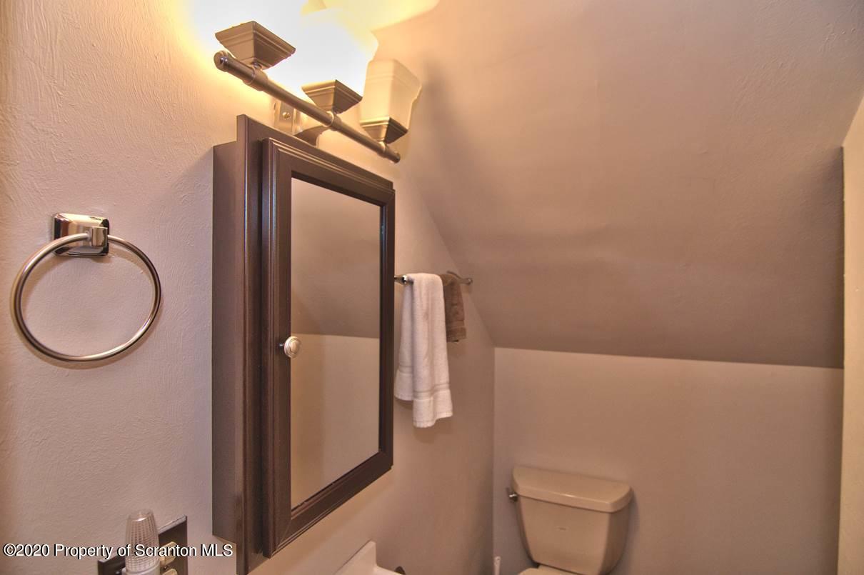 293 State Rte 1002 Tunkhannock, PA 18657 - Photo 31 of 71 a bathroom with a toilet and a mirror