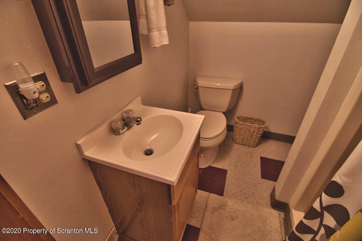 293 State Rte 1002 Tunkhannock, PA 18657 - Photo 32 of 71 a bathroom with a sink and mirror with toilet