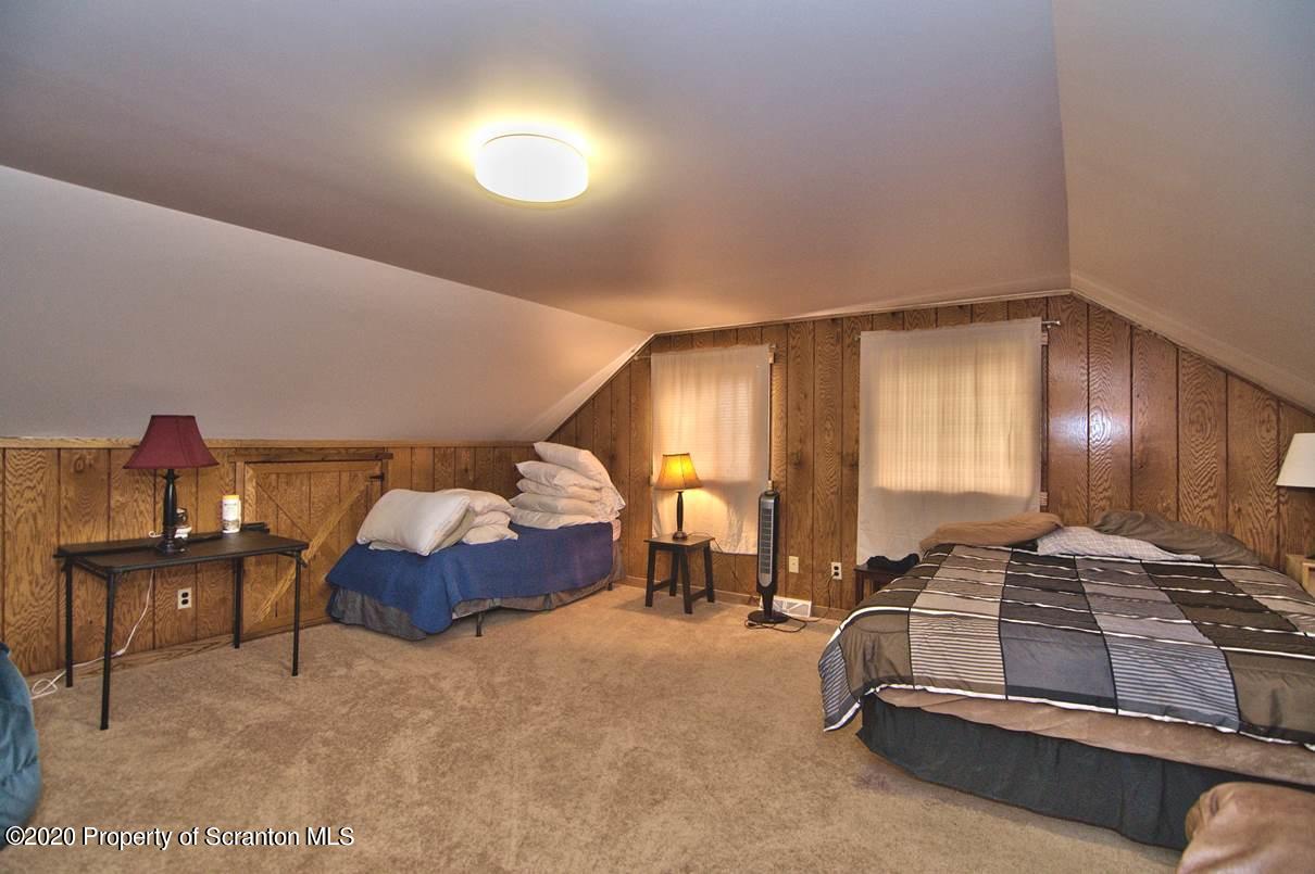 293 State Rte 1002 Tunkhannock, PA 18657 - Photo 35 of 71 a spacious bedroom with a bed and a chandelier