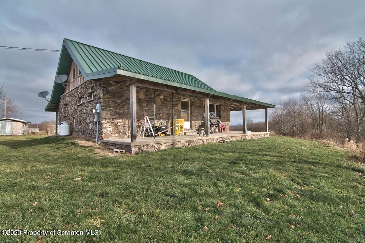 293 State Rte 1002 Tunkhannock, PA 18657 - Photo 4 of 71 a front view of a house with garden