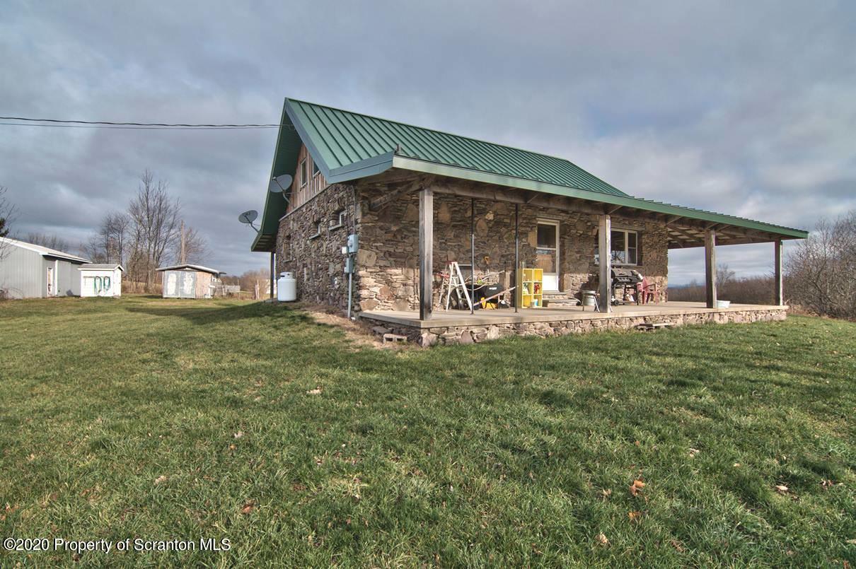 293 State Rte 1002 Tunkhannock, PA 18657 - Photo 42 of 71 a front view of a house with garden