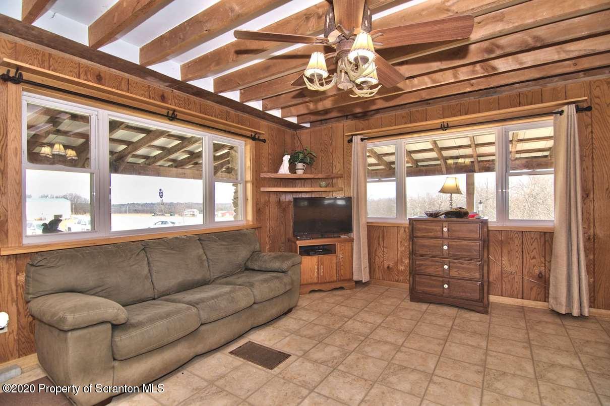 293 State Rte 1002 Tunkhannock, PA 18657 - Photo 6 of 71 a living room with furniture and a large window
