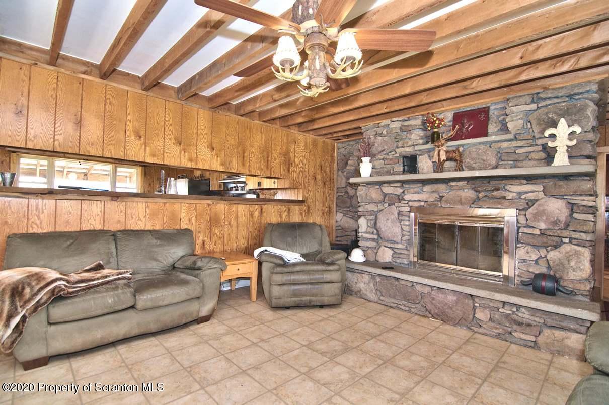 293 State Rte 1002 Tunkhannock, PA 18657 - Photo 9 of 71 a living room with furniture and a fireplace
