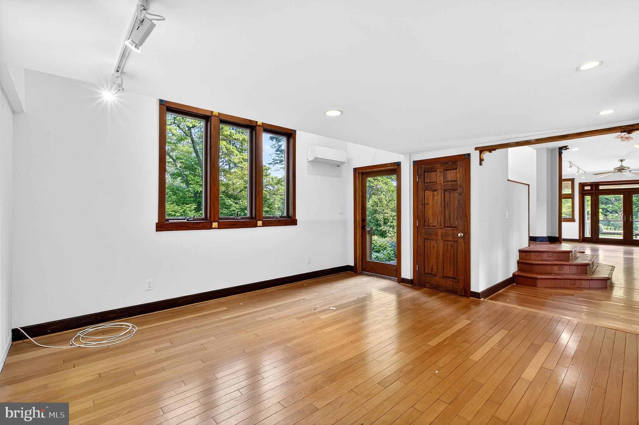 498 Perrineville Road Robbinsville, NJ 08691 - Photo 20 of 59 an empty room with wooden floor and windows