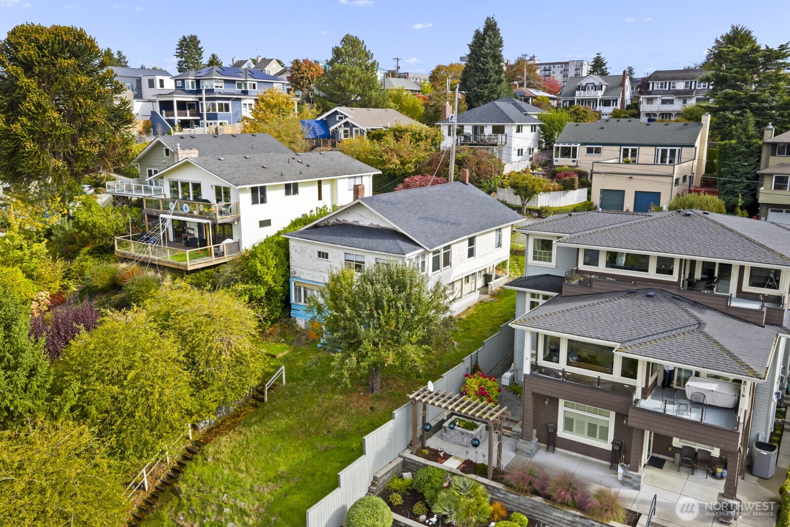an aerial view of multiple houses with a yard