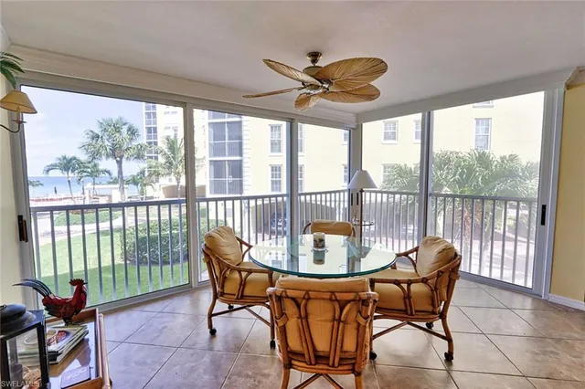 a dining room with furniture a chandelier and glass door