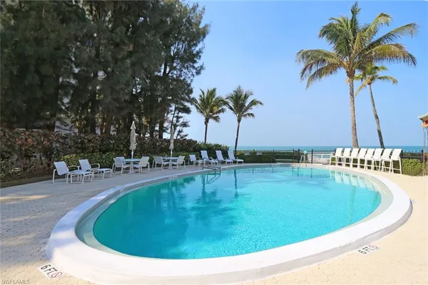 a view of a swimming pool with chairs