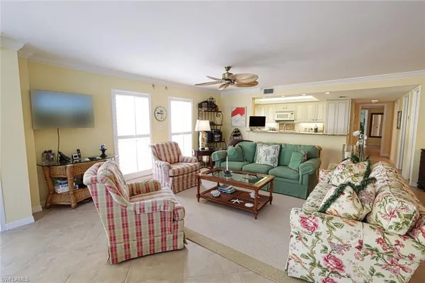 a living room with furniture and a chandelier
