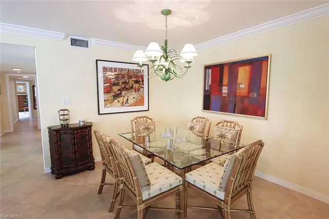 a dining room with furniture and chandelier