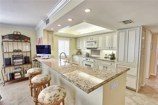 a kitchen with stainless steel appliances granite countertop a stove and a sink