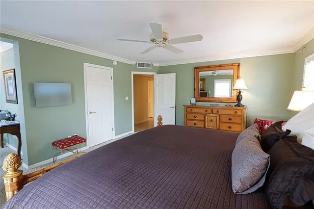 a bed room with a bed and a television