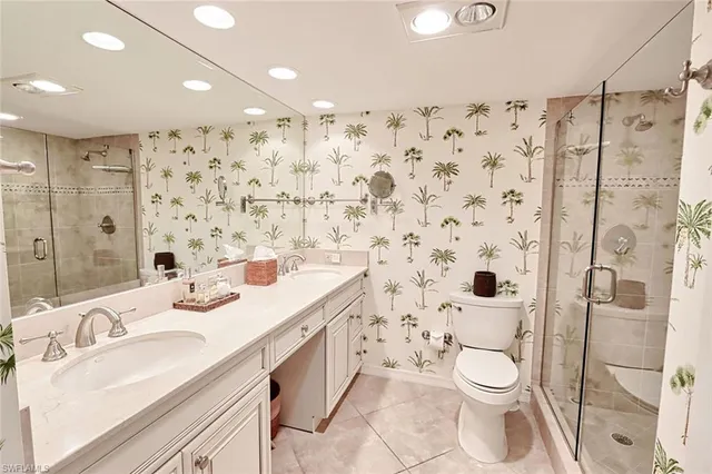 a bathroom with a sink toilet a shower and a mirror