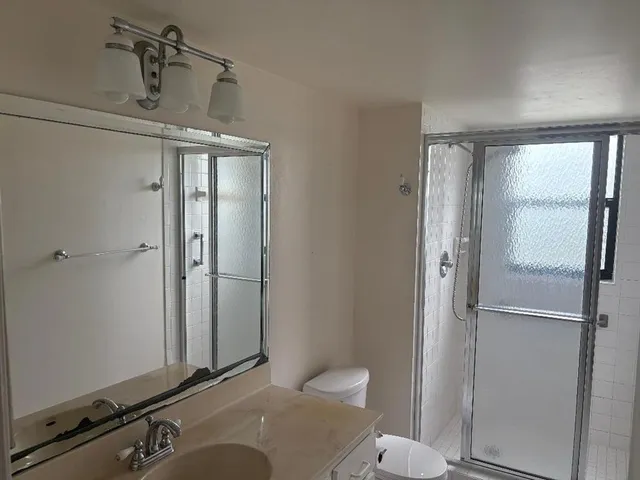 a bathroom with a glass shower door