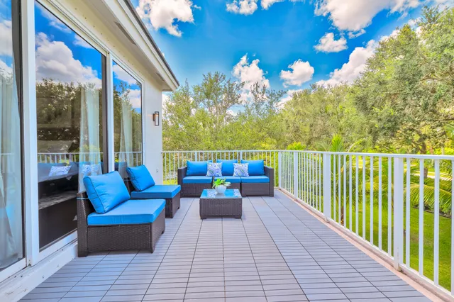 a living room with furniture and painting on the wall next to a window