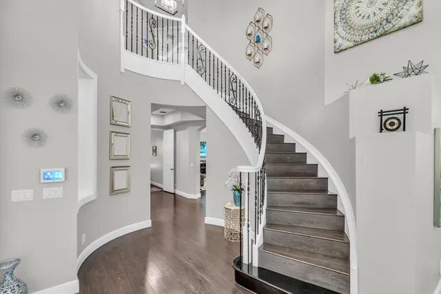 a living room with furniture ceiling fan and a large window