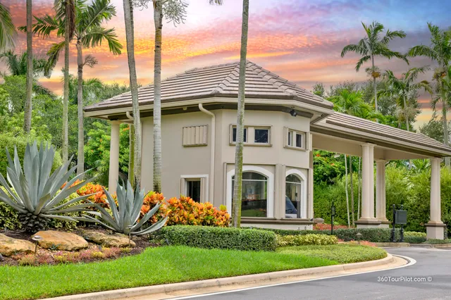 a front view of a house with a garden and trees