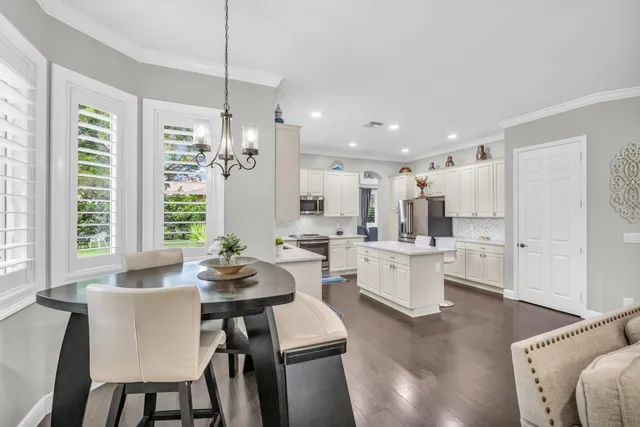 a spacious bedroom with a bed a couch and a large window with wooden floor